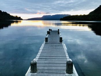 Scenic view of swimming pool by lake against sky