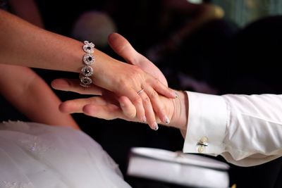 Close-up of couple holding hands