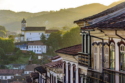 View of historic colonial style houses and church in the background on the hills of ouro preto