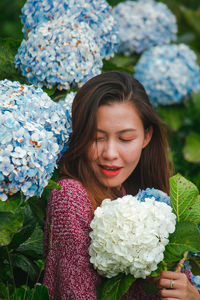 Smiling woman by flowering plants