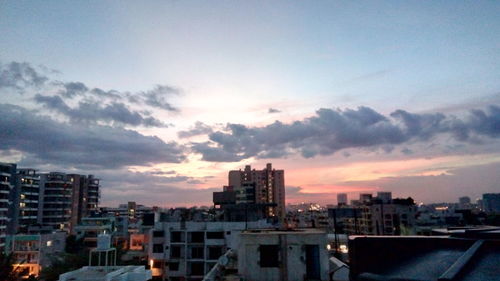 Cityscape against cloudy sky