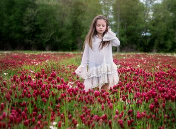 Portrait of young woman standing on field