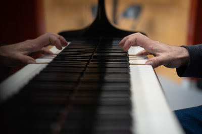 Cropped hand playing piano