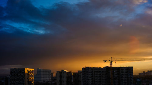 Silhouette buildings against sky during sunset