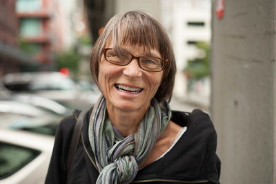 Close-up portrait of senior woman wearing muffler at harbor