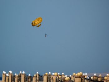 Low angle view of person parachuting in blue sky at dusk