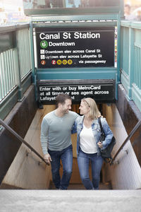 Couple leaving subway station