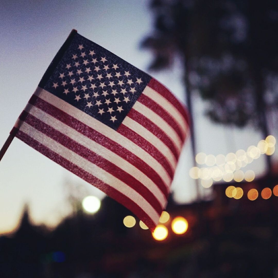 low angle view, patriotism, flag, american flag, identity, national flag, red, sky, star shape, celebration, culture, hanging, christmas, decoration, no people, close-up, tradition, outdoors, striped, illuminated