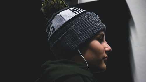 Side view of man in black background