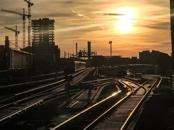 High angle view of railroad tracks in city during sunset