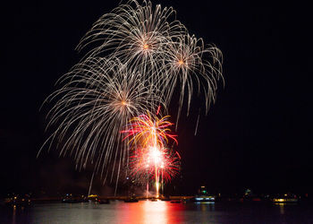 Low angle view of firework display at night