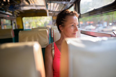 Portrait of woman sitting in bus