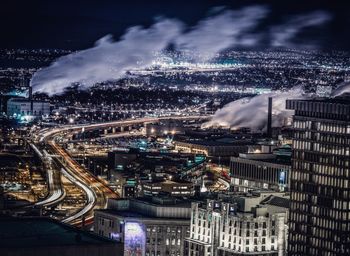 Aerial view of illuminated cityscape against sky at night