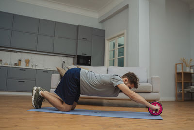 Full length of woman exercising in gym