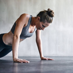 Determined woman doing push ups on floor