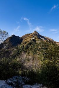 Low angle view of mountain against blue sky