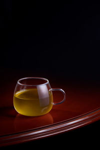 Close-up of tea cup against black background