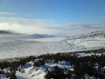 Scenic view of snow covered mountains against sky