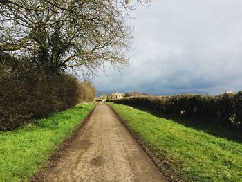 Dirt road along countryside landscape