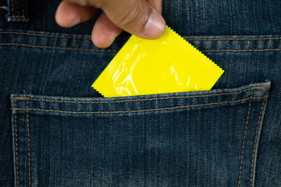 Close-up of person holding yellow umbrella