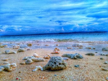 Scenic view of sea against cloudy sky