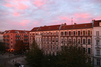 Buildings in city against cloudy sky