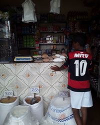 Rear view of people standing at store