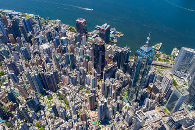 High angle view of crowd by sea against buildings in city