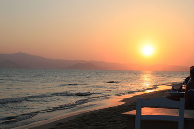 Scenic view of sea against orange sky
