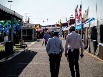 Rear view of men walking on footpath at nebraska state fair