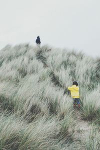 Woman standing on grassy field