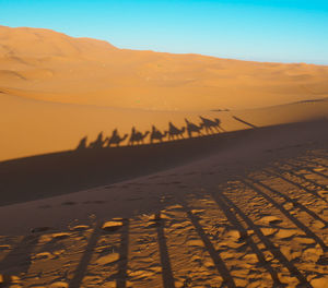 Scenic view of desert against sky during sunset