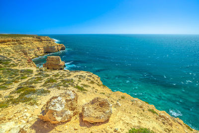 Scenic view of sea against clear blue sky