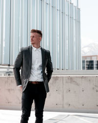 Full length of a young man looking away