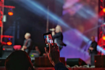 Group of people photographing at music concert