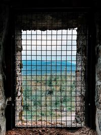 Metal fence by window in abandoned building