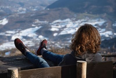 Woman sitting on bench looking at view