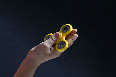 Close-up of woman hand against black background