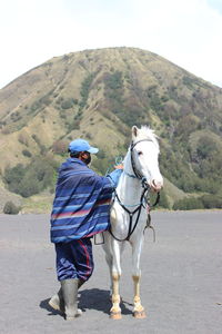 A man with horse in bromo mountain