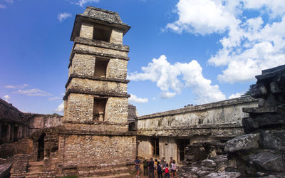 Low angle view of old building against cloudy sky