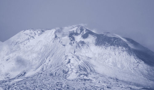 Scenic view of snowcapped mountains against clear sky