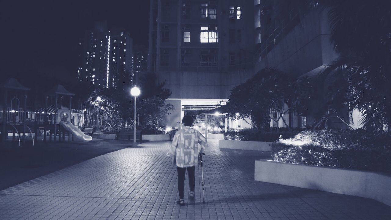 night, illuminated, architecture, building exterior, built structure, street, city, outdoors, real people, tree, walking, winter, full length, one person, people