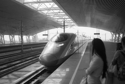 Blurred motion of woman at railroad station