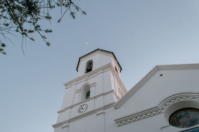 Low angle view of clock tower against sky