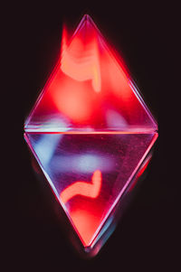 Close-up of illuminated heart shape over black background
