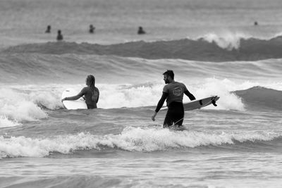 Rear view of people on beach