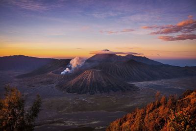 View of volcanic landscape against sky during sunset