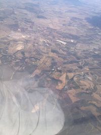 Aerial view of landscape seen through airplane window