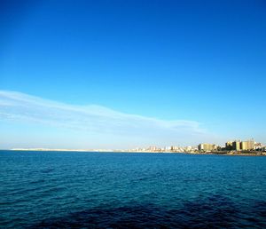 Scenic view of sea against blue sky