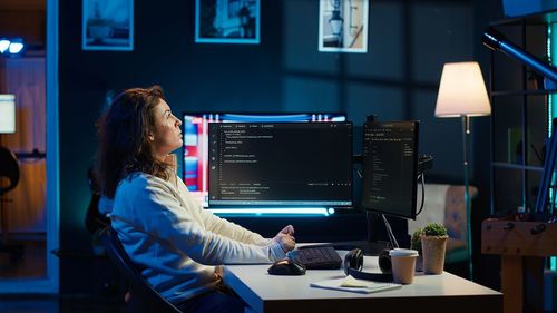 Midsection of woman using laptop